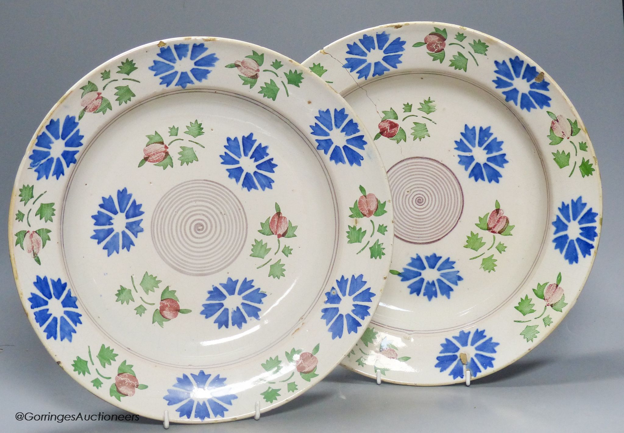 A pair of Continental polychrome faience chargers, late 19th century, height 33cm - one cracked